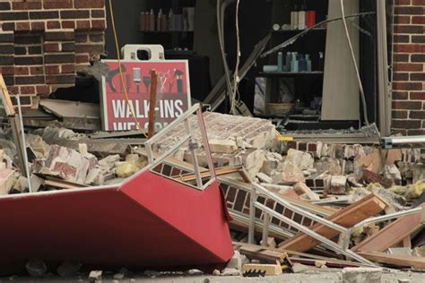 Minivan strikes building, leaving roof sagging and turning much of its facade to pile of bricks